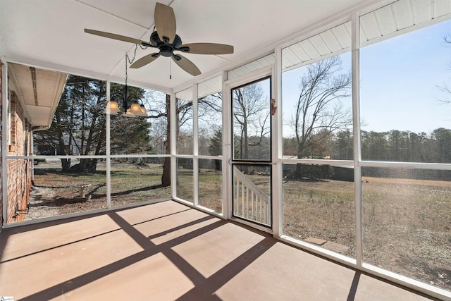 unfurnished sunroom with plenty of natural light and a ceiling fan