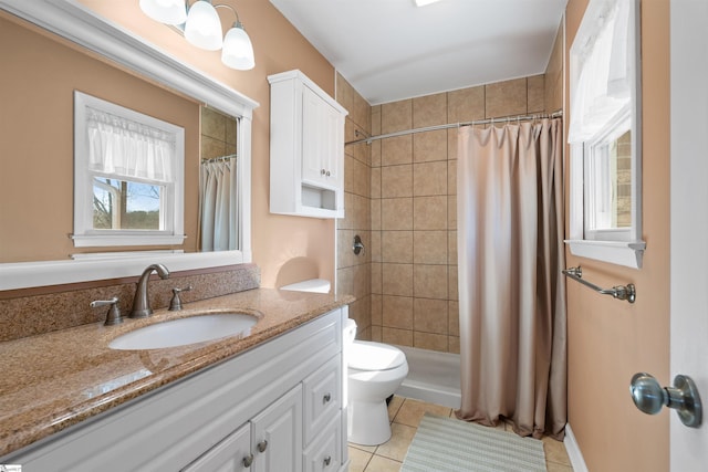 bathroom with vanity, a shower stall, toilet, and tile patterned floors