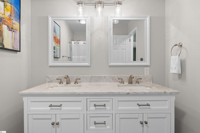 bathroom featuring double vanity and a sink