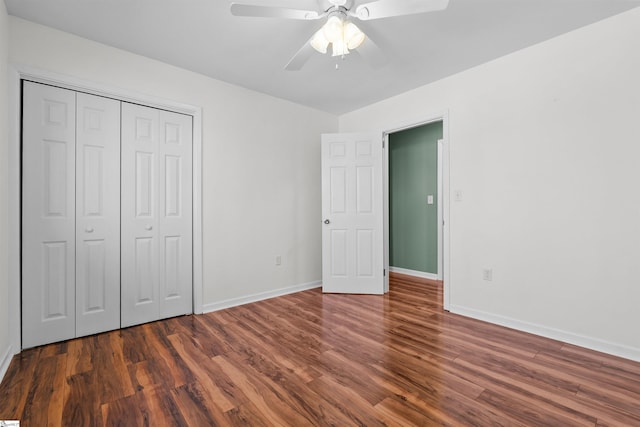 unfurnished bedroom with ceiling fan, a closet, baseboards, and wood finished floors