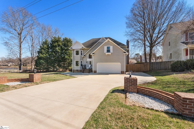 traditional-style home featuring an attached garage, fence, concrete driveway, crawl space, and a front yard