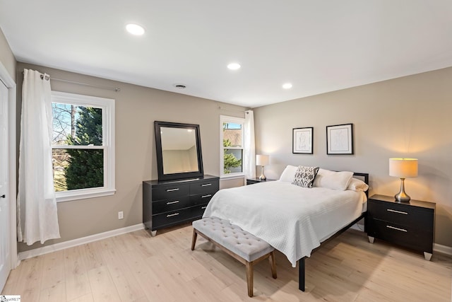 bedroom featuring light wood-type flooring, baseboards, and recessed lighting