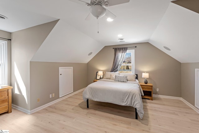 bedroom with light wood finished floors, ceiling fan, baseboards, and vaulted ceiling