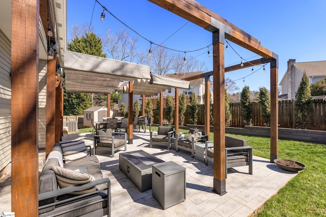 view of patio featuring an outbuilding, outdoor lounge area, fence, a pergola, and a storage unit