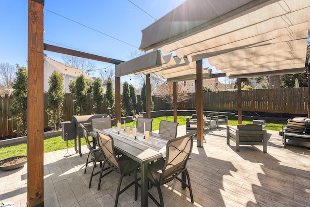 view of patio with outdoor dining space, a fenced backyard, and a pergola