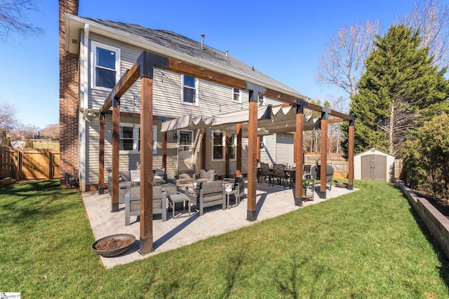 back of property featuring an outbuilding, a patio area, a shed, an outdoor living space, and a pergola