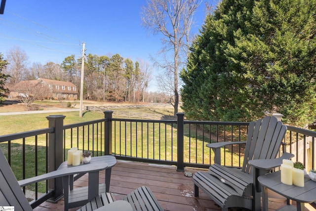 wooden deck featuring a lawn