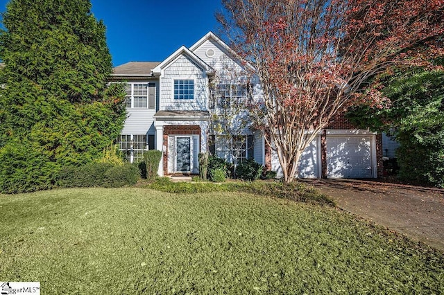 view of front facade featuring driveway, a garage, a front lawn, and brick siding