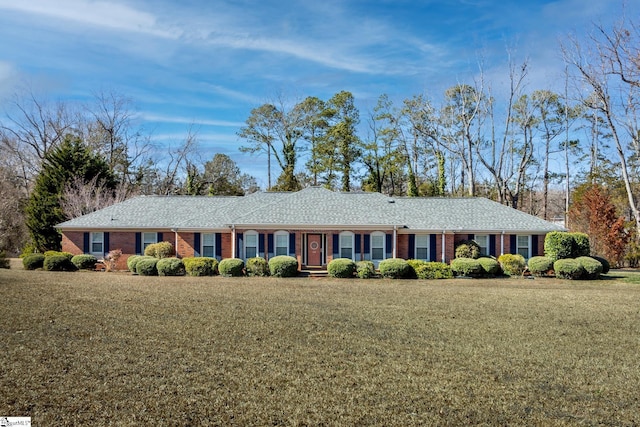 single story home with brick siding and a front yard