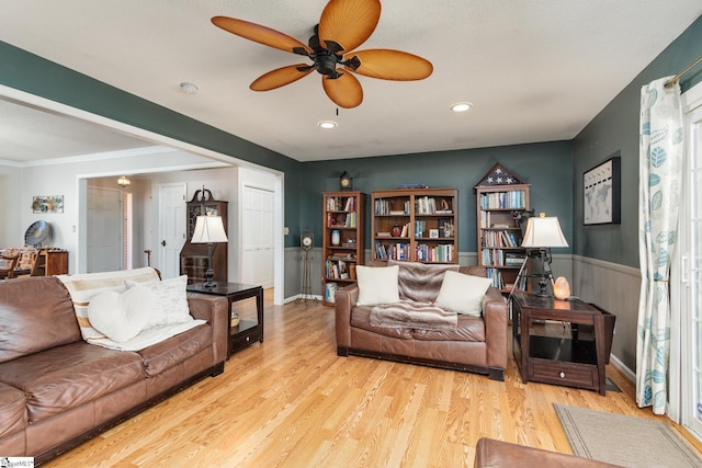 living room with recessed lighting, a wainscoted wall, ceiling fan, and wood finished floors