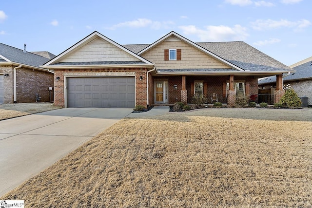 craftsman inspired home featuring driveway, brick siding, an attached garage, and a front yard