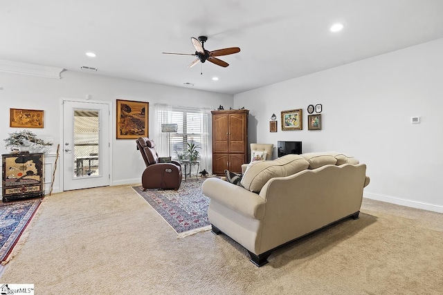 living room with light colored carpet, visible vents, and baseboards