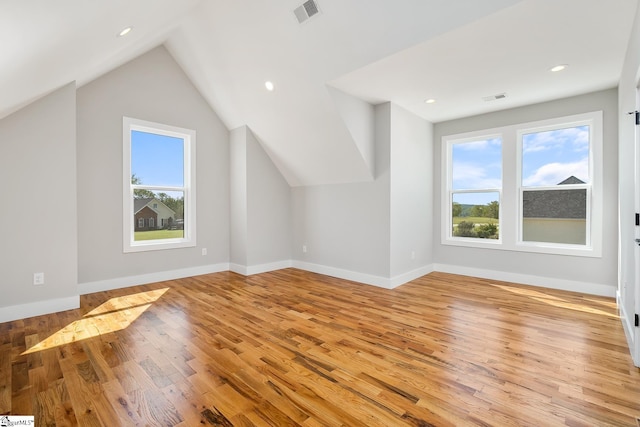 bonus room featuring light wood-type flooring, baseboards, and visible vents