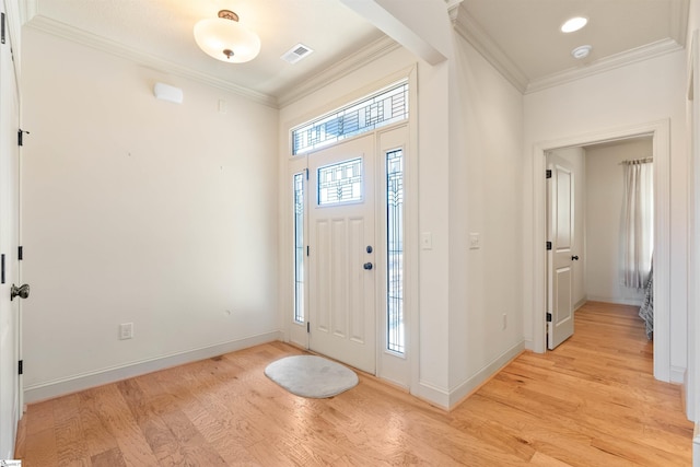 foyer entrance featuring light wood-style floors, visible vents, crown molding, and baseboards