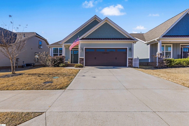 craftsman inspired home featuring a garage, driveway, central AC unit, and a front yard