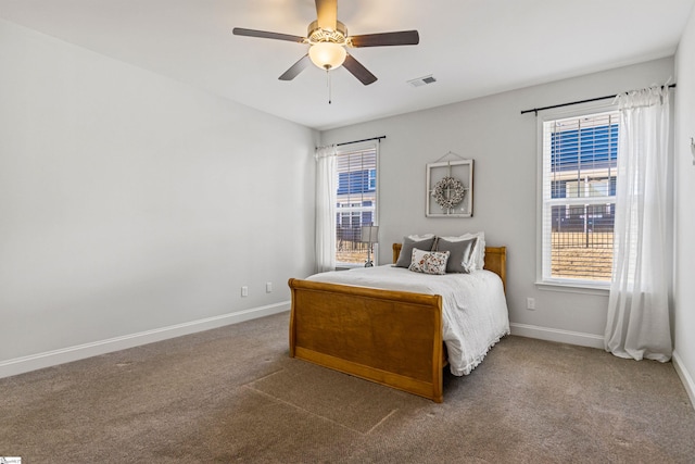 bedroom featuring carpet floors, multiple windows, visible vents, and baseboards