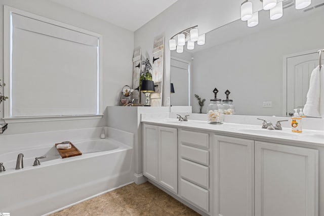 full bathroom with double vanity, a garden tub, visible vents, and a sink