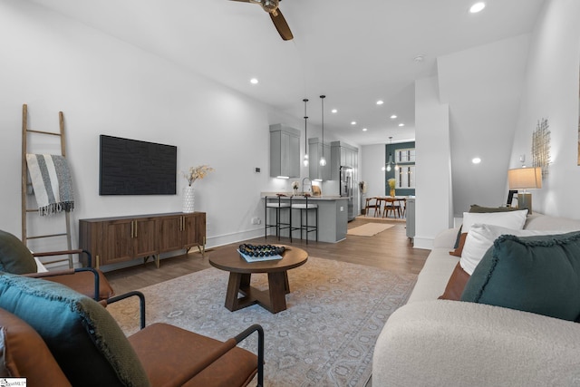 living area featuring ceiling fan, wood finished floors, and recessed lighting