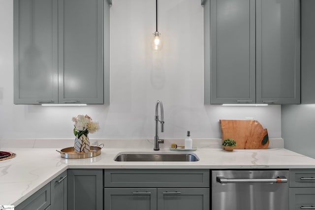 kitchen featuring a sink, light stone counters, gray cabinets, and dishwasher