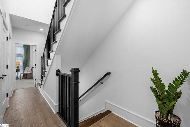 stairway featuring wood finished floors and baseboards