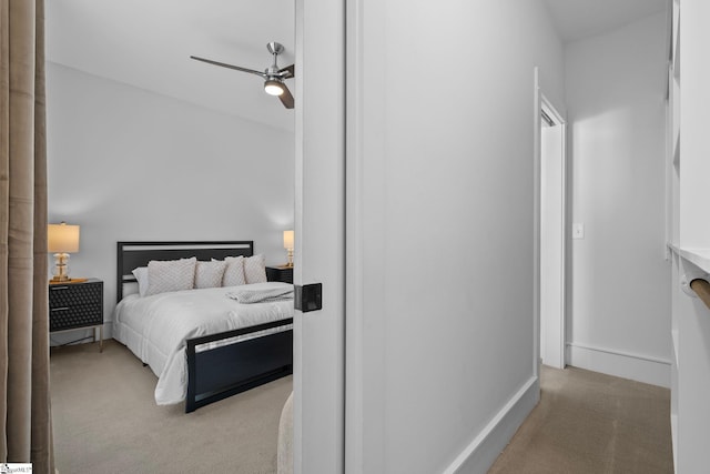 carpeted bedroom featuring ceiling fan and baseboards