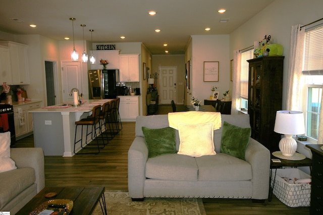 living room featuring dark wood-type flooring and recessed lighting