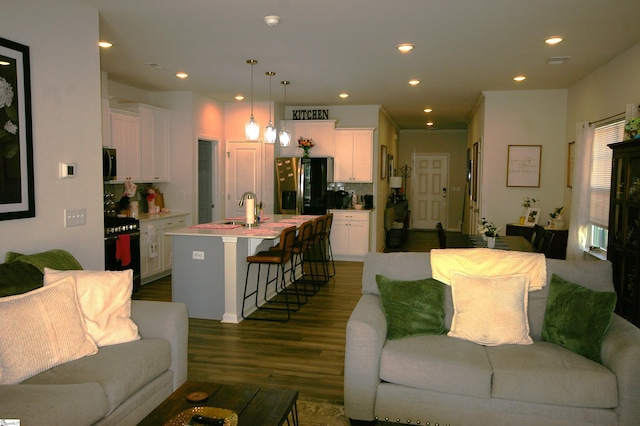 living room featuring dark wood finished floors and recessed lighting