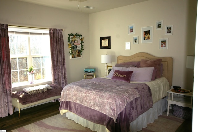 bedroom with visible vents and wood finished floors