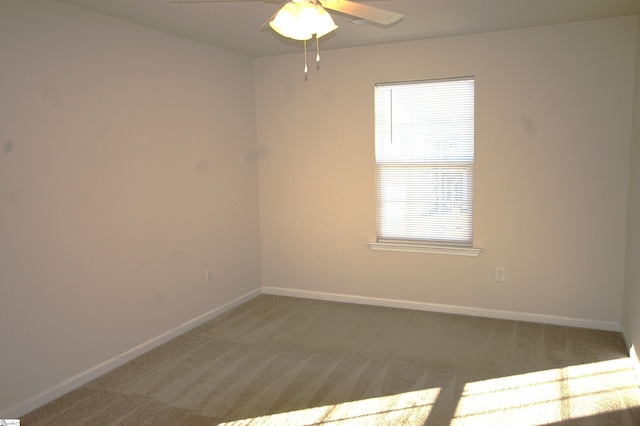 unfurnished room with a ceiling fan, carpet flooring, and baseboards