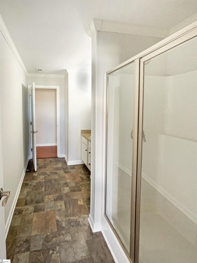 full bathroom featuring visible vents, baseboards, stone finish floor, a stall shower, and crown molding