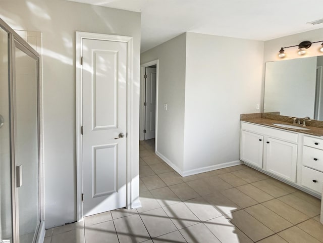 full bath featuring tile patterned floors, a shower stall, baseboards, and vanity