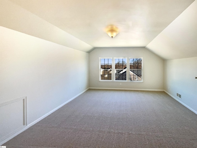 bonus room featuring vaulted ceiling, carpet, visible vents, and baseboards