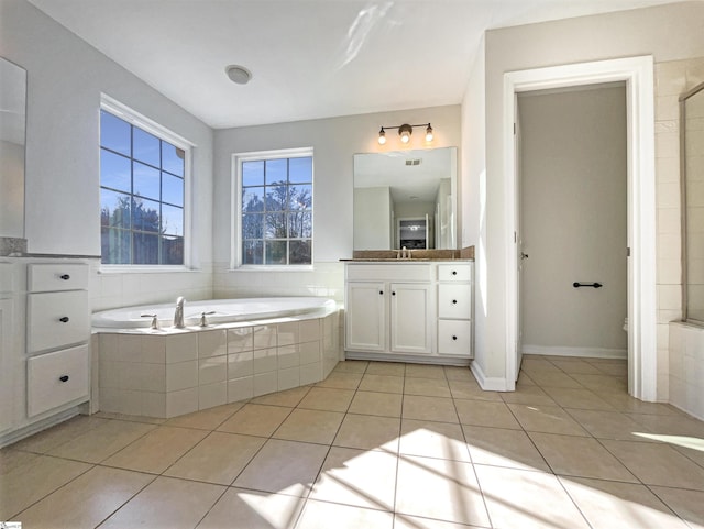 full bath featuring tile patterned flooring, a bath, and vanity