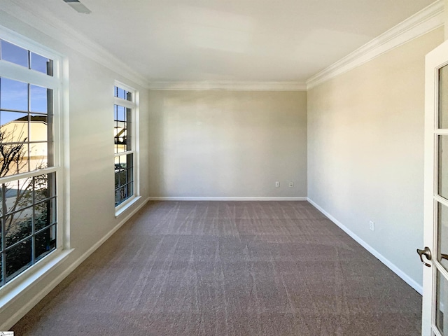 spare room featuring baseboards, crown molding, and carpet flooring