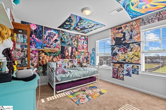 bedroom with carpet floors, baseboards, and visible vents