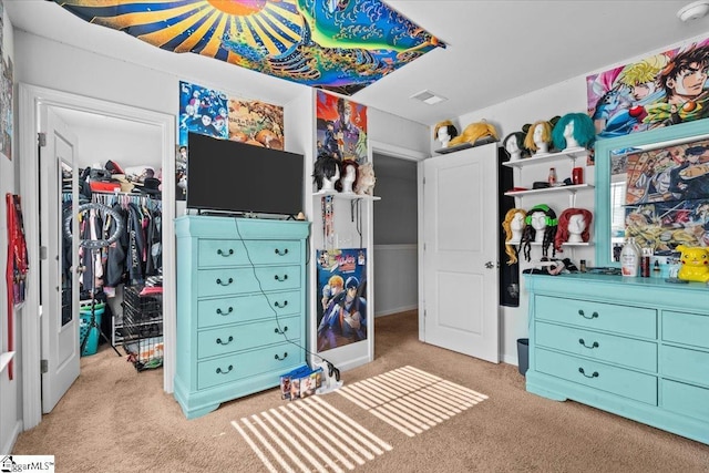 bedroom featuring carpet floors, a closet, visible vents, and a spacious closet