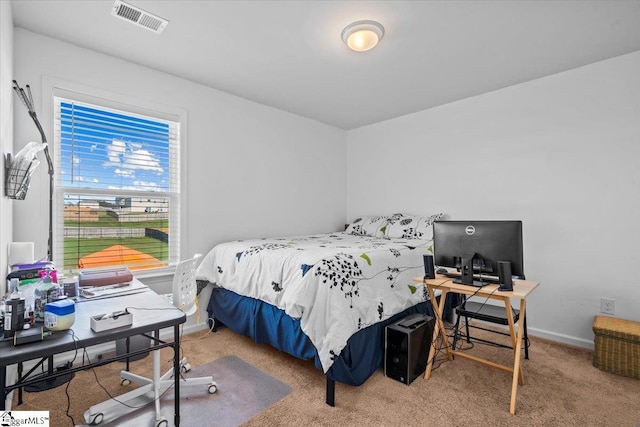 carpeted bedroom featuring baseboards and visible vents