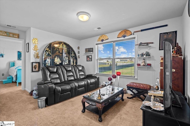 living room featuring carpet floors, visible vents, and baseboards