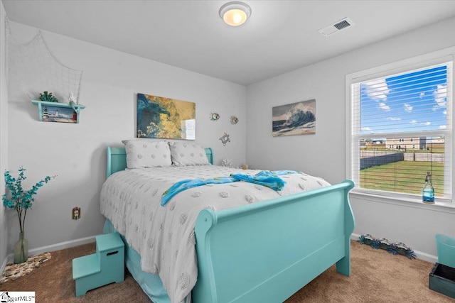 carpeted bedroom with baseboards and visible vents