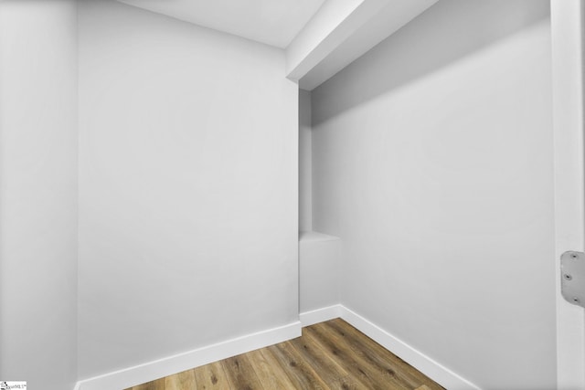 interior space with baseboards and dark wood-style flooring