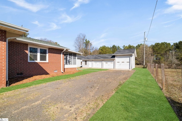 exterior space with crawl space, brick siding, fence, and a front lawn