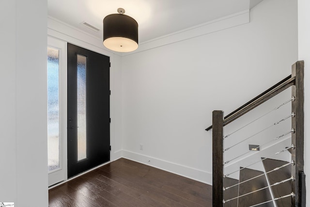 entrance foyer featuring stairway, visible vents, baseboards, and dark wood-type flooring