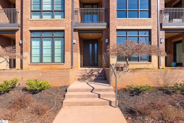 doorway to property with brick siding