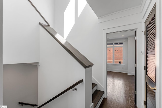 staircase with baseboards and wood finished floors