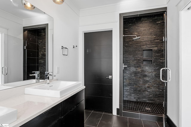 bathroom with a stall shower, crown molding, vanity, and tile patterned floors