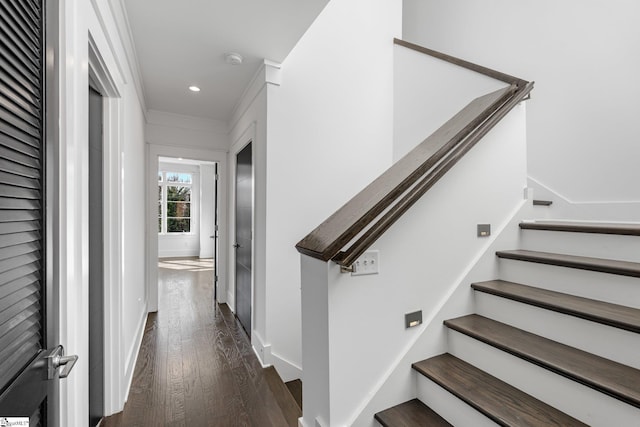 stairs with wood finished floors and recessed lighting