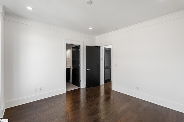 spare room with baseboards, wood finished floors, and recessed lighting