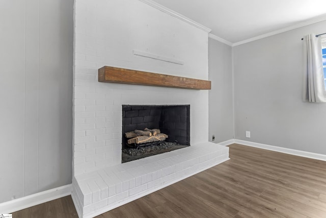 interior details with a brick fireplace, baseboards, ornamental molding, and wood finished floors