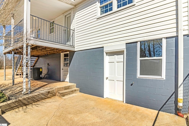 doorway to property with a patio area and central AC unit