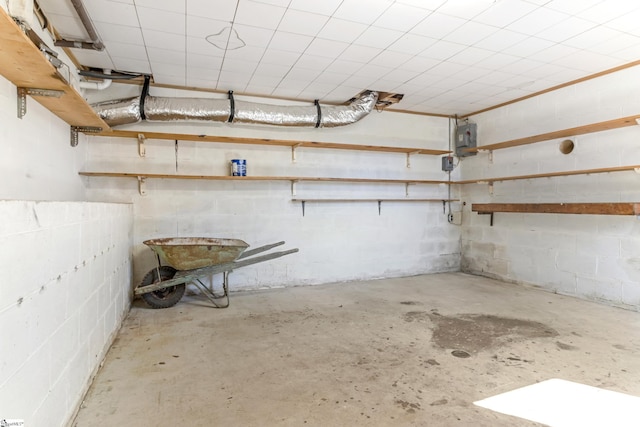 basement with a garage and concrete block wall